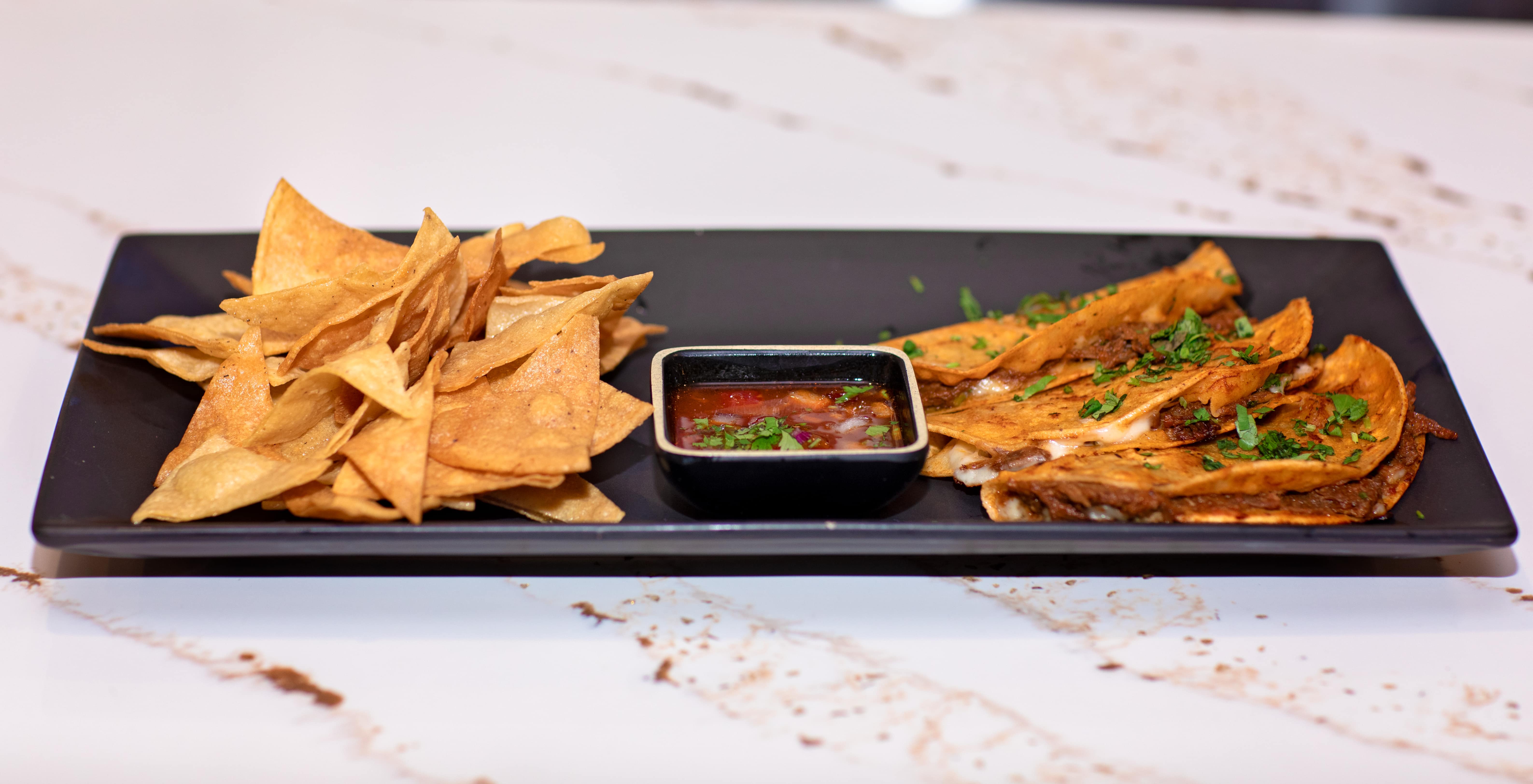 Birria tacos with chips and salsa