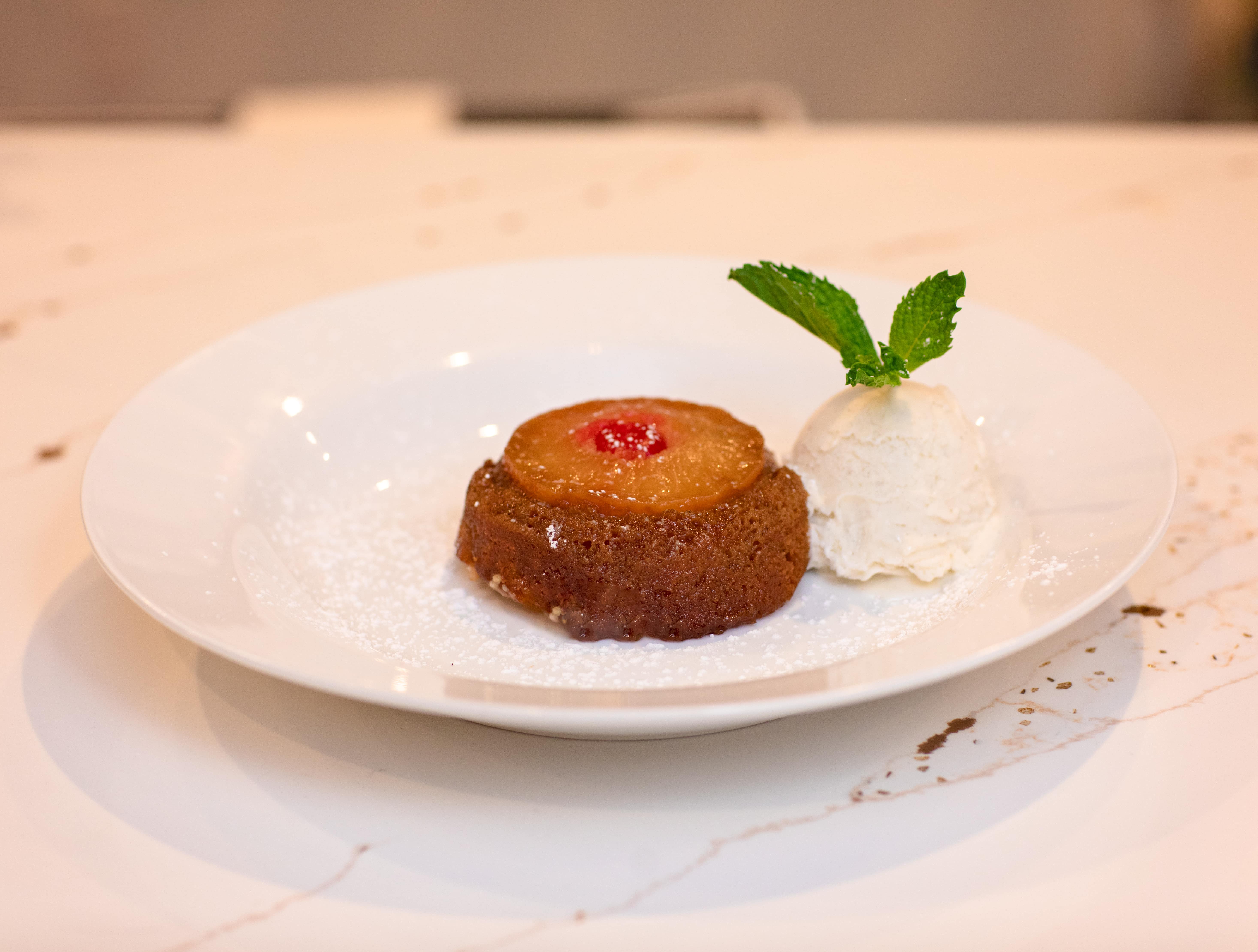 Pineapple upside-down cake with a scoop of vanilla ice cream