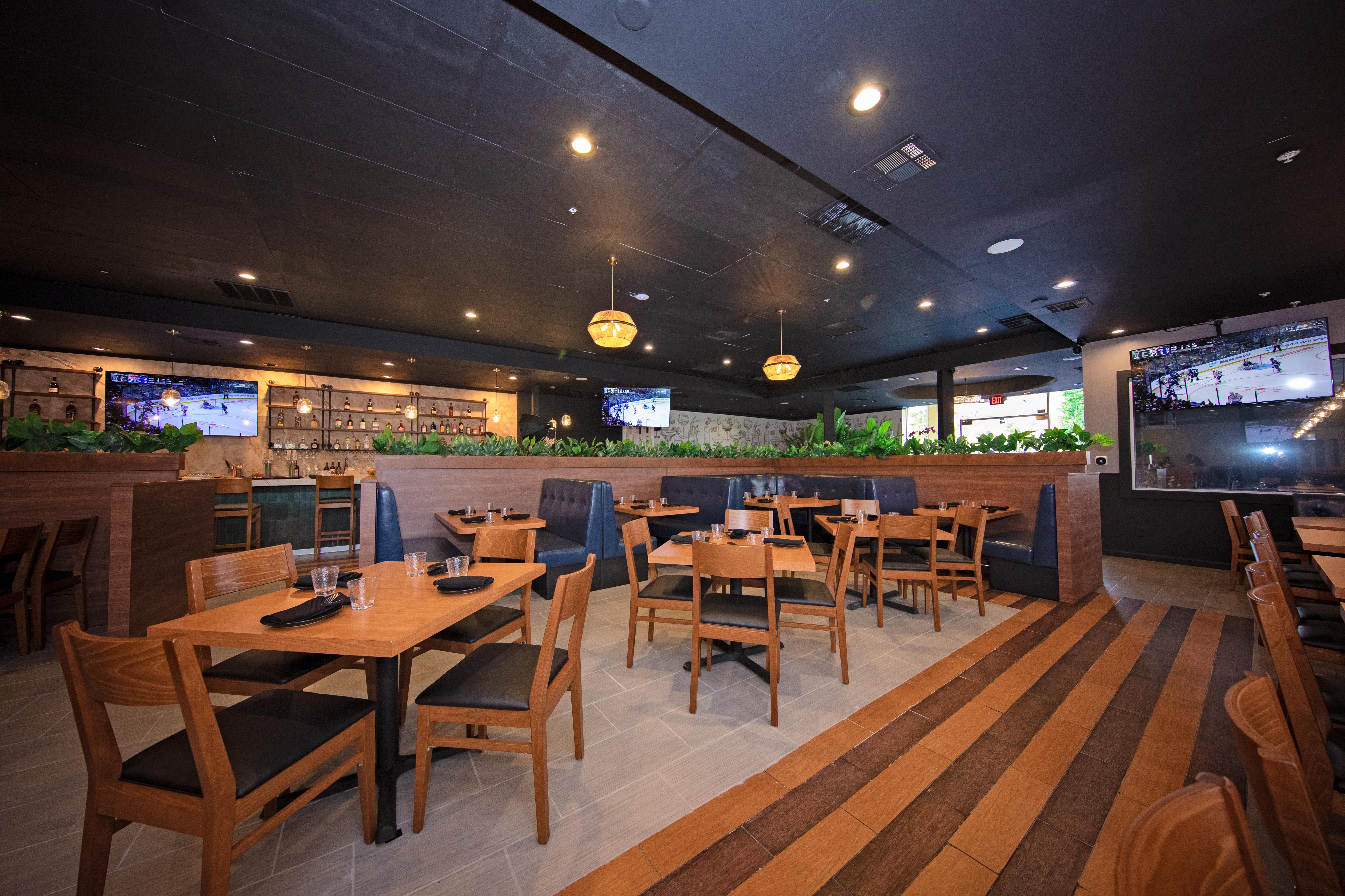 Dining area with striped wood floors and pendant lighting