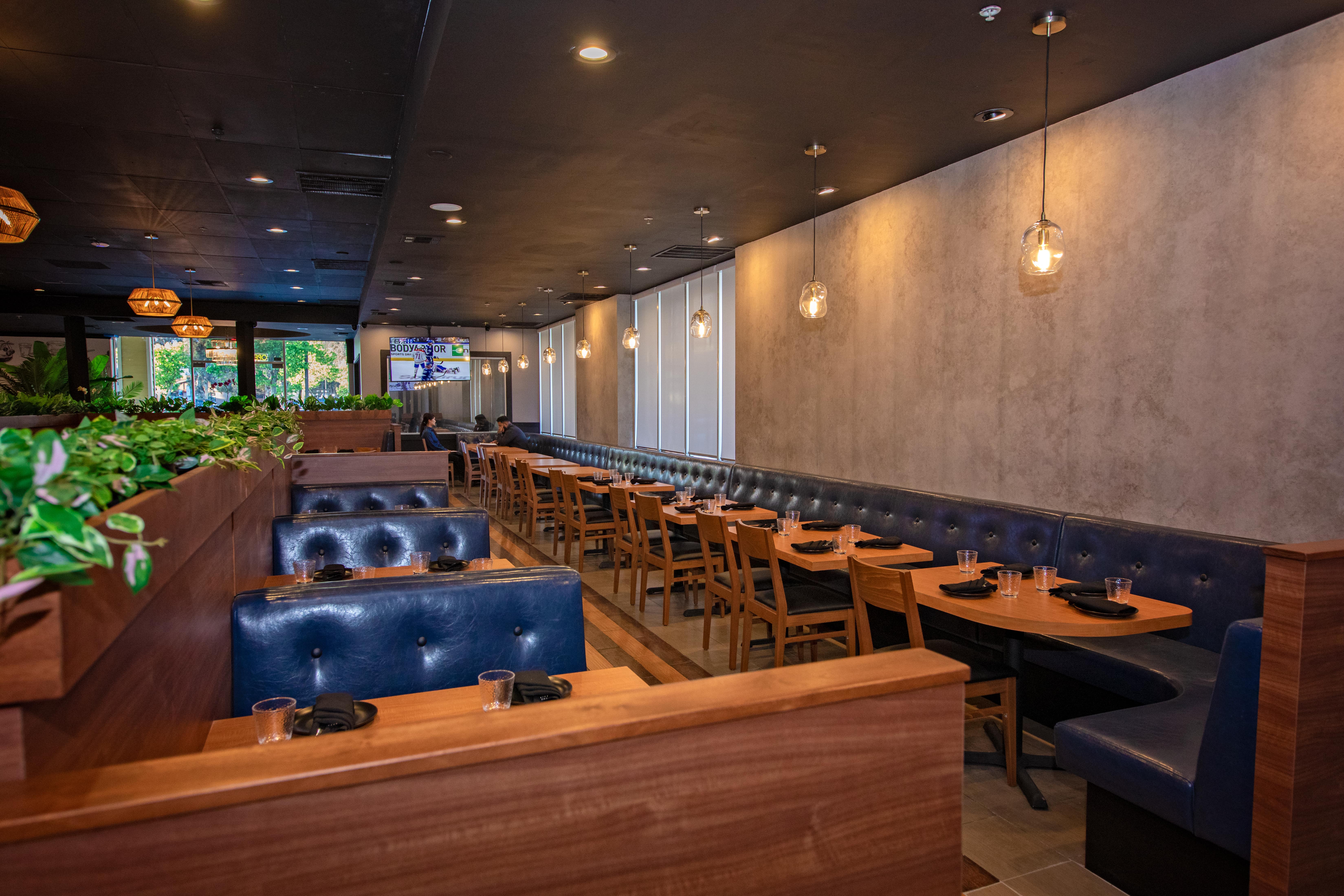 Blue leather banquette seating beneath globe pendant lights