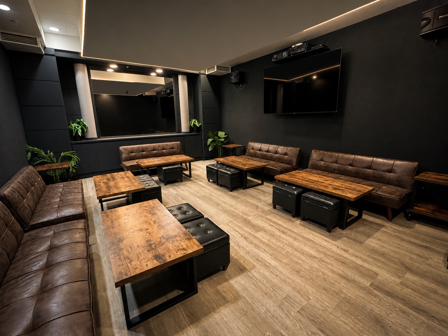 The private room at Toast & Tonique with lounge seating, wood tables, and a dedicated TV